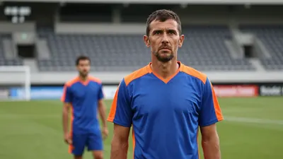 A 35-year-old, lean, Eastleigh fitness coach in a plain, blue and orange, technical training top, stands on the...